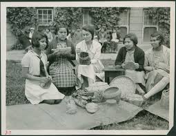 Young girls practicing basket weaving